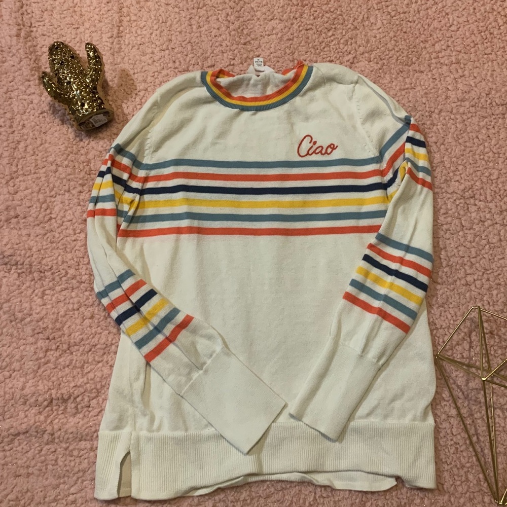 A white sweater with rainbow stripes